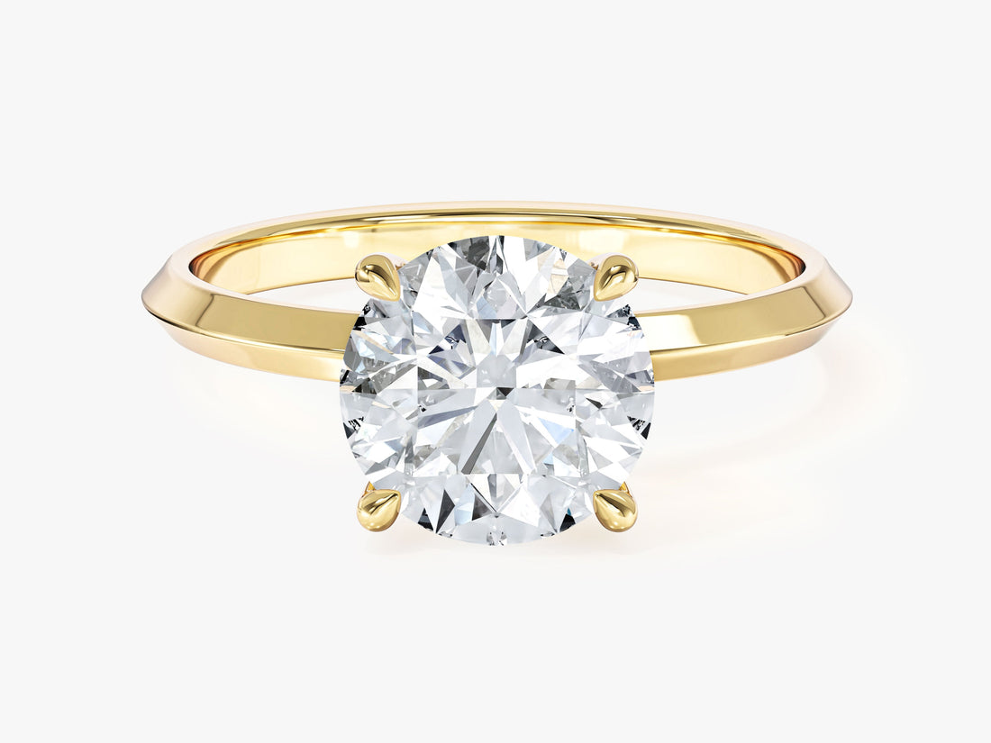 Round lab grown diamond four claw engagement ring with knife edge band in yellow gold, front view