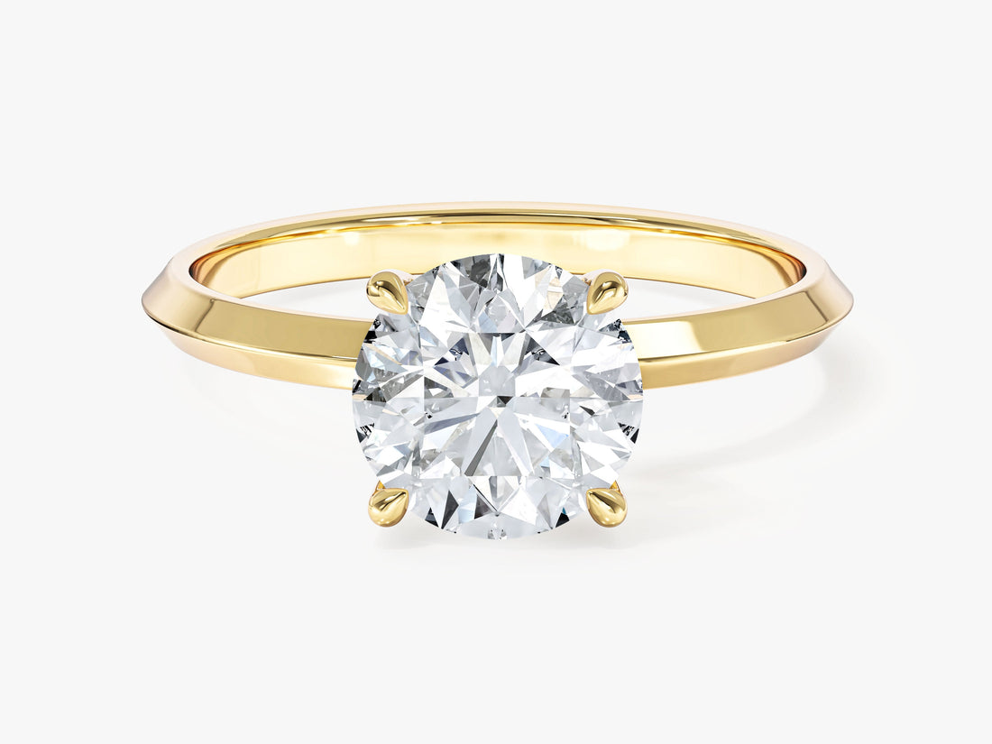 Round lab grown diamond solitaire with tapered knife edge shank in yellow gold, front view