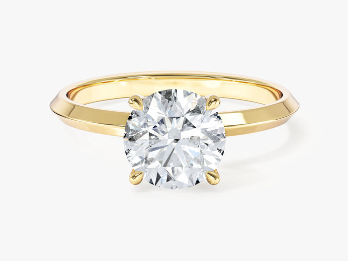 Round lab grown diamond solitaire with tapered knife edge shank in yellow gold, front view