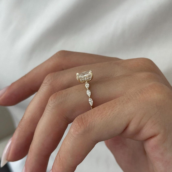 Radiant cut moissanite engagement ring with marquise and round accent band in yellow gold, view 2