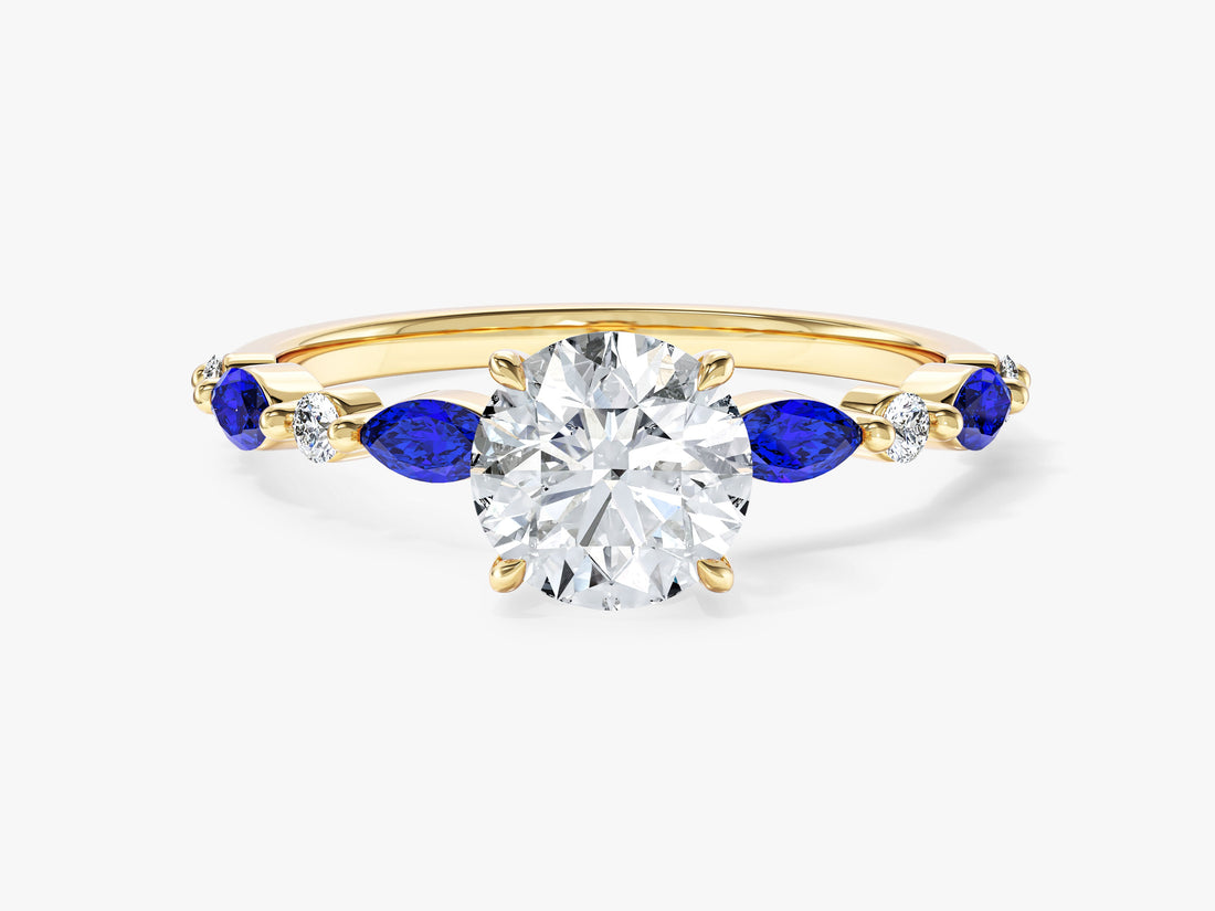 Round moissanite four claw engagement ring with marquise station band in 14K yellow gold, blue display side stones