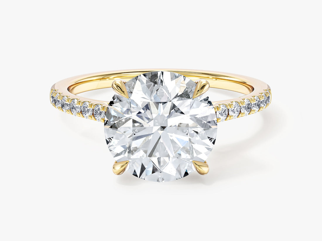 Round lab grown diamond four claw engagement ring with petite pave band in yellow gold, front view