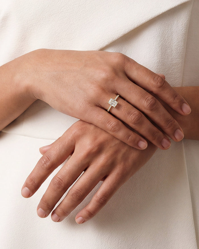 Radiant moissanite pave band engagement ring in yellow gold worn on the hand