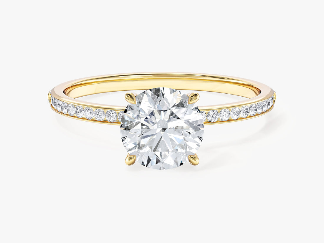 Round cut moissanite solitaire engagement ring with channel set band in yellow gold, front view
