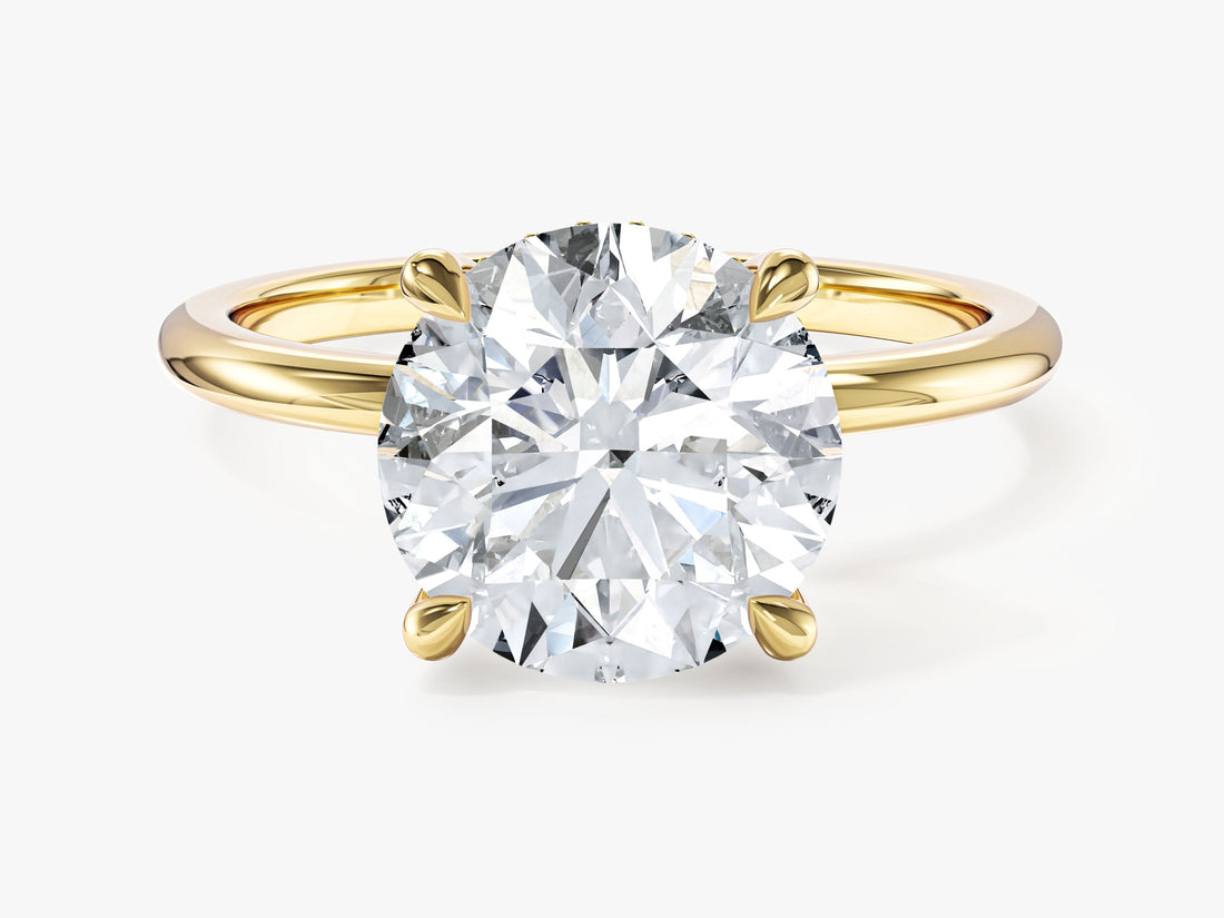 Large round lab grown diamond secret halo engagement ring in yellow gold, front view