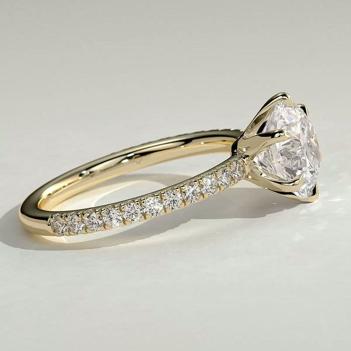 Round brilliant moissanite six claw solitaire engagement ring on a pave yellow gold band, view 2