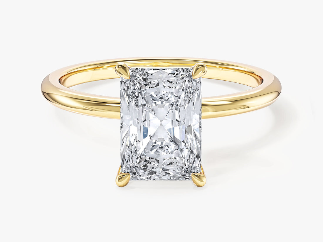 Radiant cut moissanite solitaire engagement ring with four corner claws in yellow gold, front view
