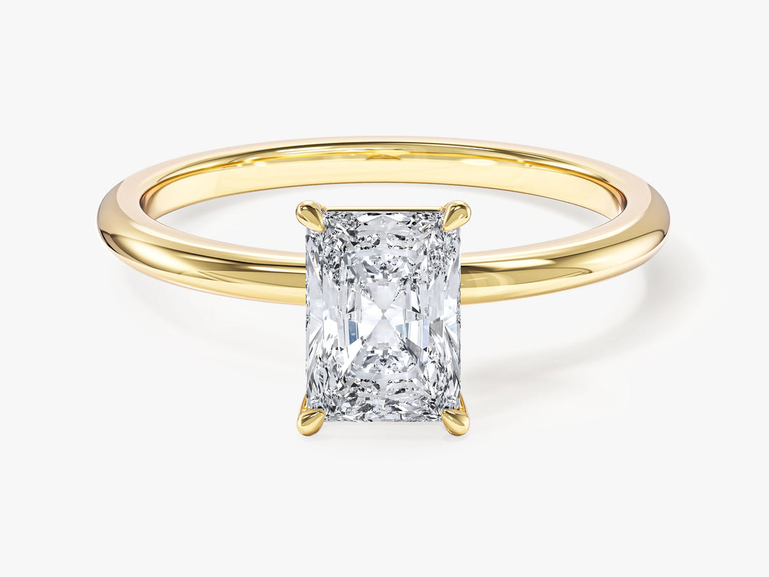 Dainty radiant cut moissanite solitaire engagement ring on a thin band in yellow gold, front view