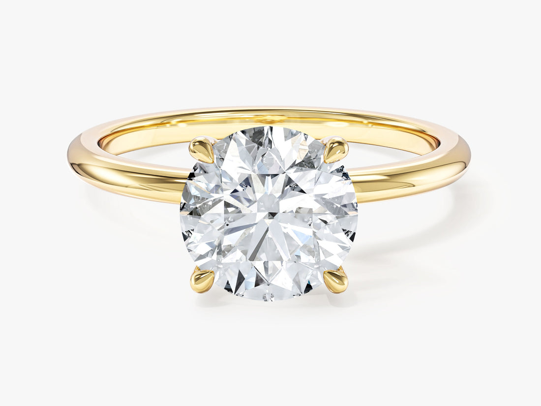 Round lab grown diamond four prong solitaire with thin plain band in yellow gold, front view