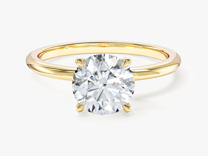 Round lab grown diamond solitaire with four claw basket and plain shank in yellow gold, front view