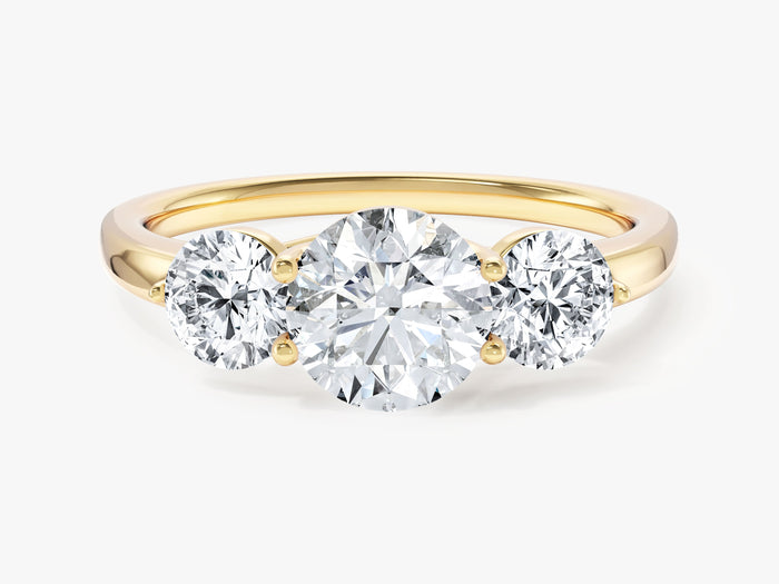 Round lab grown diamond three stone engagement ring with large side diamonds in yellow gold, front view