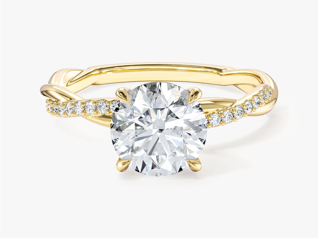 Round cut moissanite solitaire engagement ring with twisted pave band in 14K yellow gold, front view