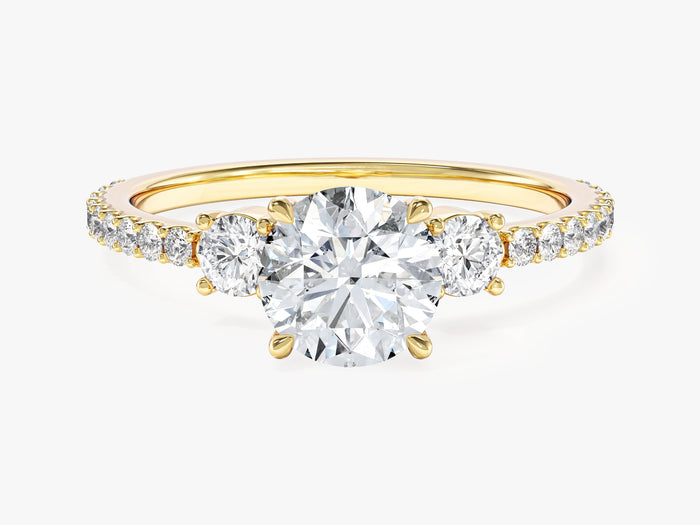 Round lab grown diamond three stone engagement ring with micro pave band in yellow gold, front view