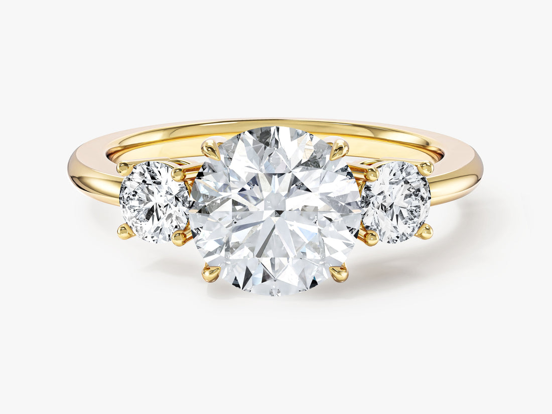Round moissanite three stone engagement ring with basket settings and plain band in 14K yellow gold, front view