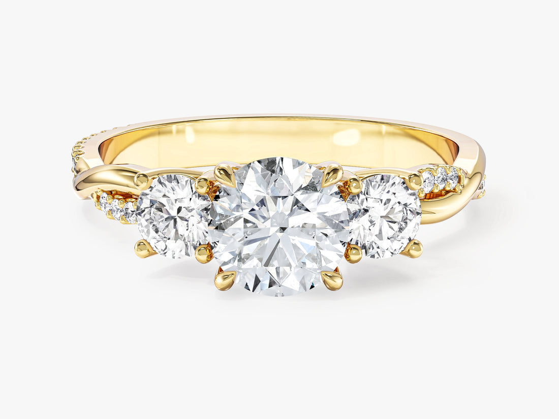 Petite round brilliant moissanite trilogy engagement ring with braided pave shank in yellow gold, front view