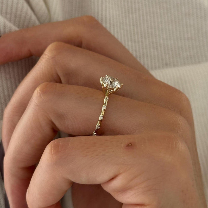 Round cut moissanite twig band engagement ring with scattered accents in yellow gold, view 2