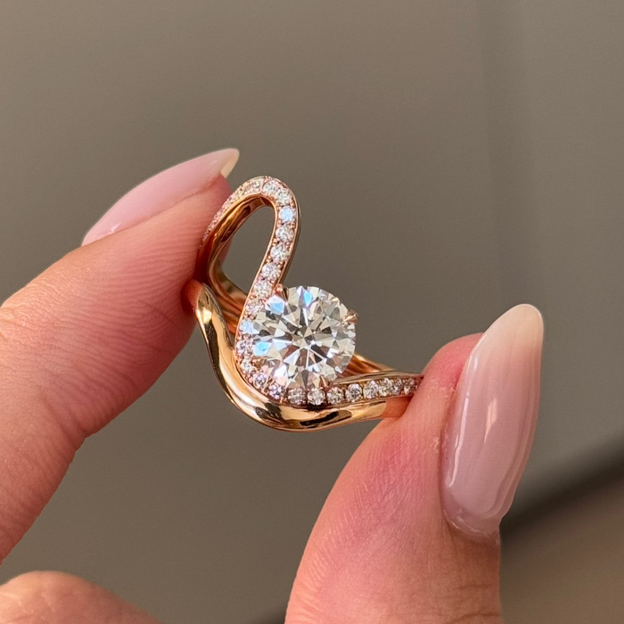Round cut moissanite twisted pave sculptural engagement ring in rose gold