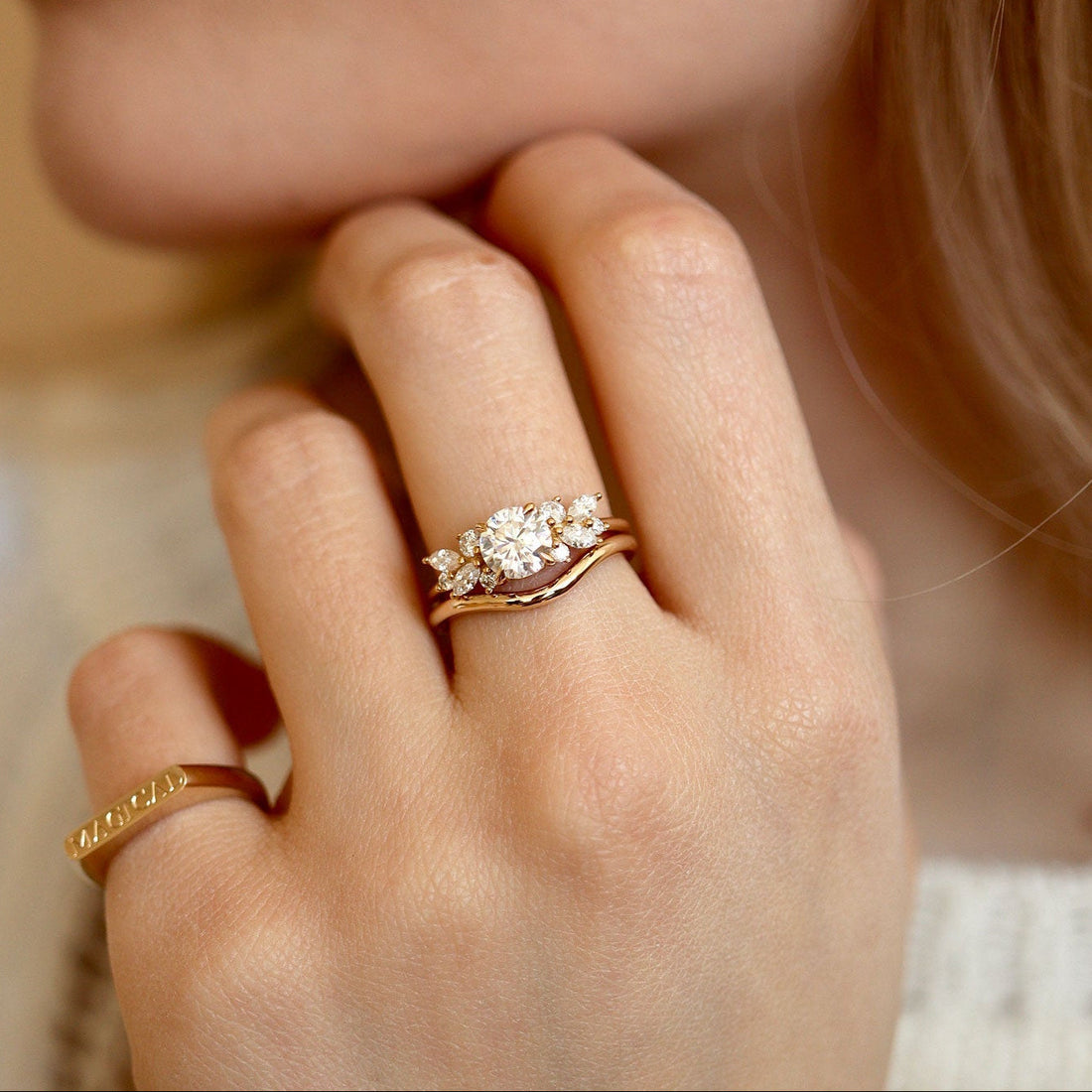 Round cut moissanite petite wing cluster engagement ring in yellow gold