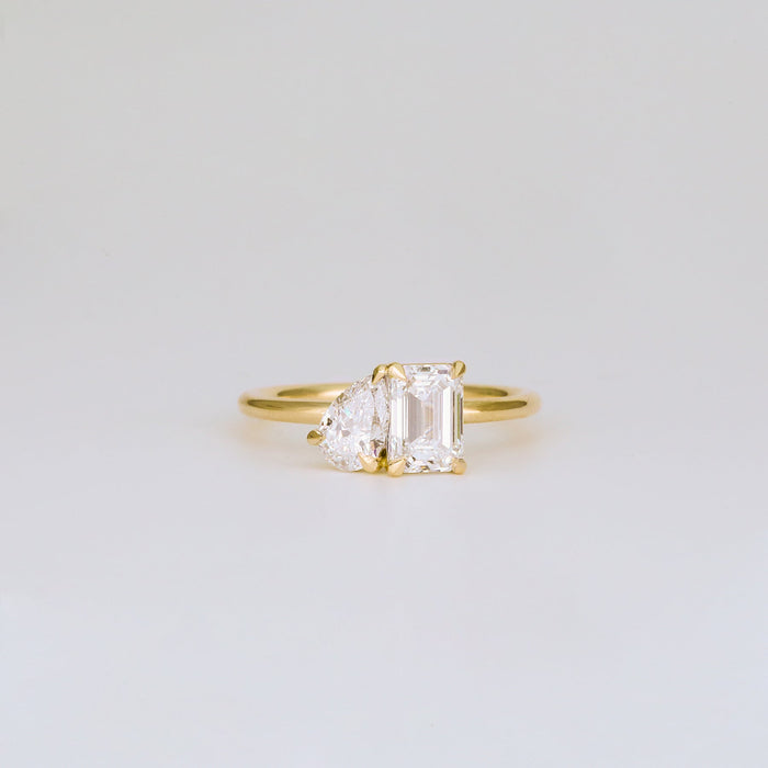 Emerald cut and half moon moissanite toi et moi engagement ring in yellow gold