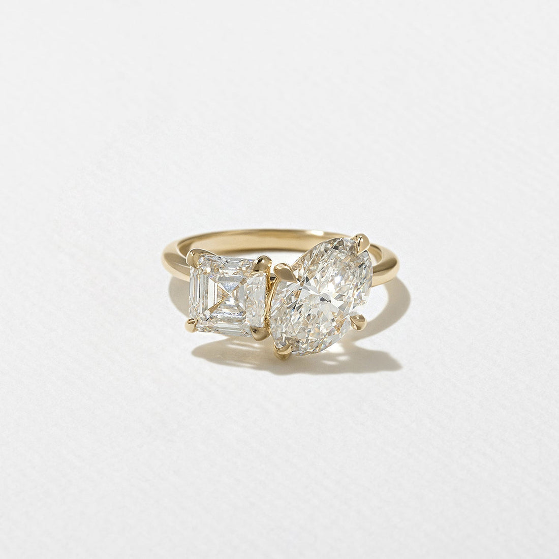 Oval and asscher cut moissanite toi et moi engagement ring in yellow gold