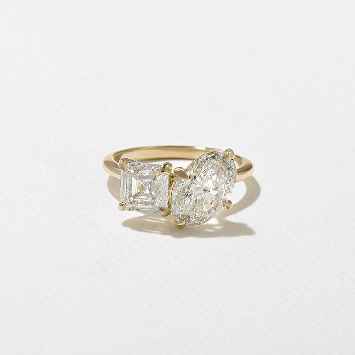 Oval and asscher cut moissanite toi et moi engagement ring in yellow gold