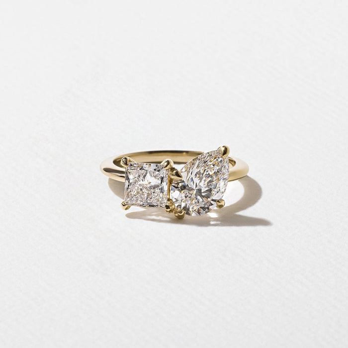 Pear and princess cut moissanite petite toi et moi engagement ring in yellow gold
