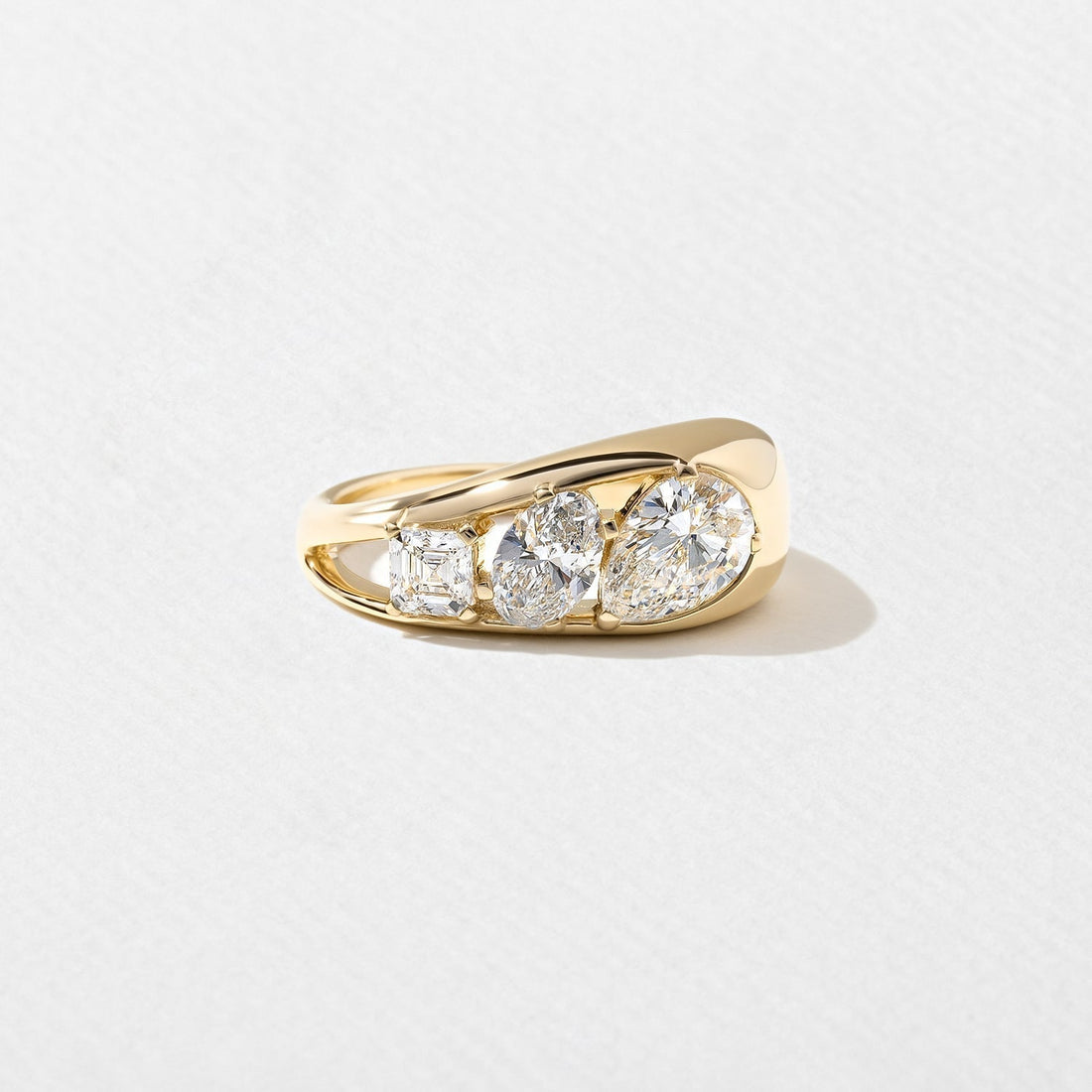 Pear oval and asscher moissanite three stone dome engagement ring in yellow gold
