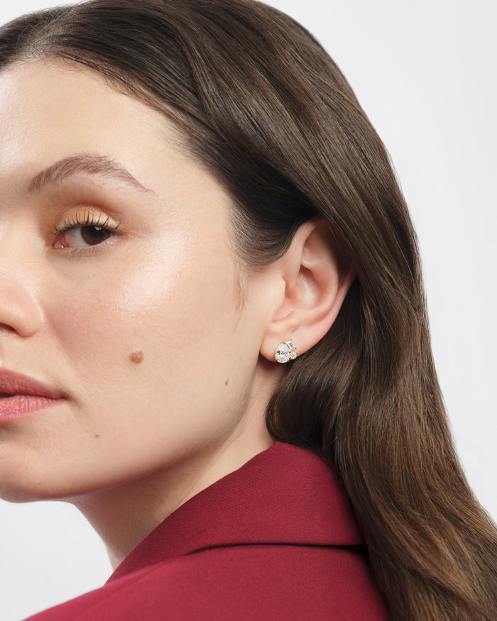 Model wearing pear mixed shape cluster lab grown diamond stud earrings, close up on the ear