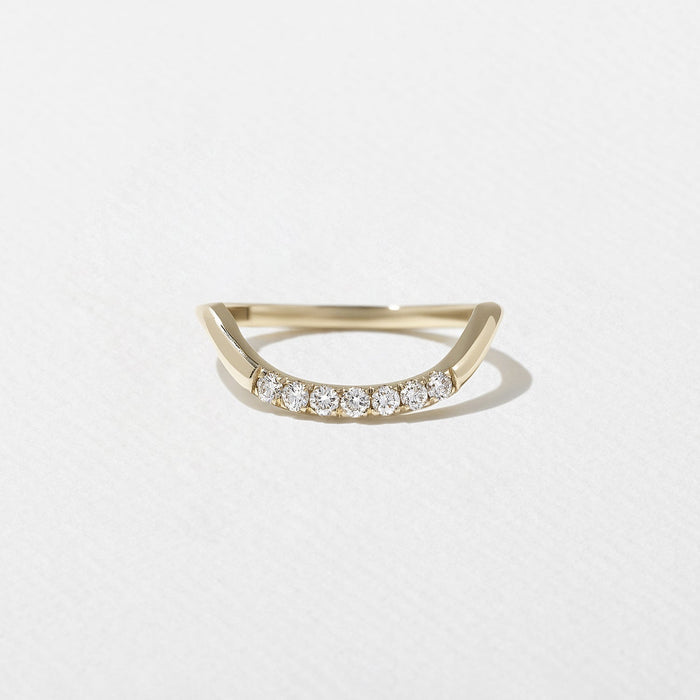 Round moissanite curved wedding band in yellow gold front view