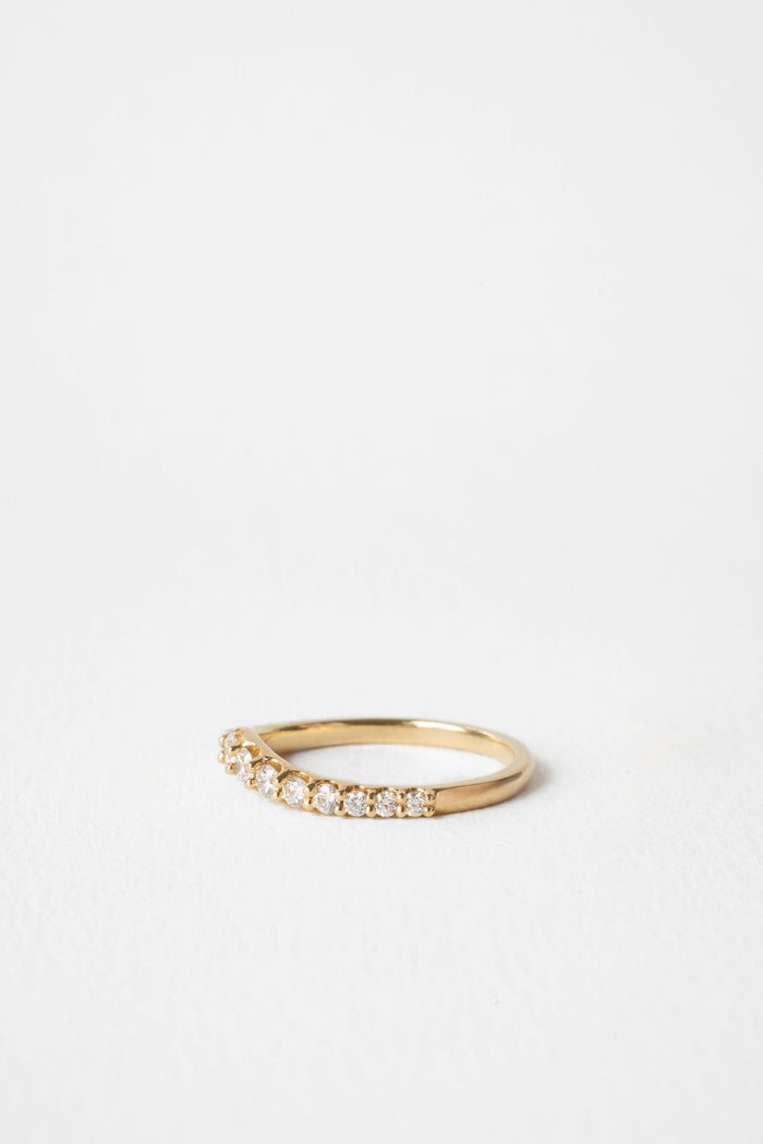 Round moissanite curved wedding band 0.55 CT TW in yellow gold, side view