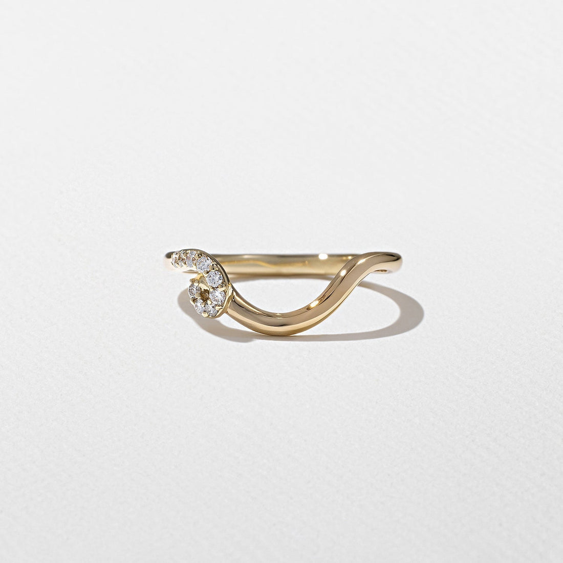 Round lab grown diamond curved swirl wedding band in yellow gold front view