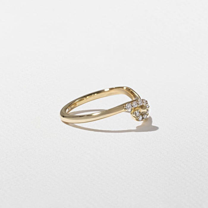 Angled view of the curved band with a swirl of small round moissanite stones