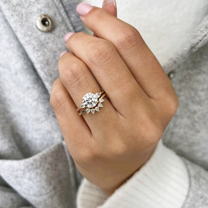 Round lab grown diamond three stone ring with pear crown band in yellow gold on the hand