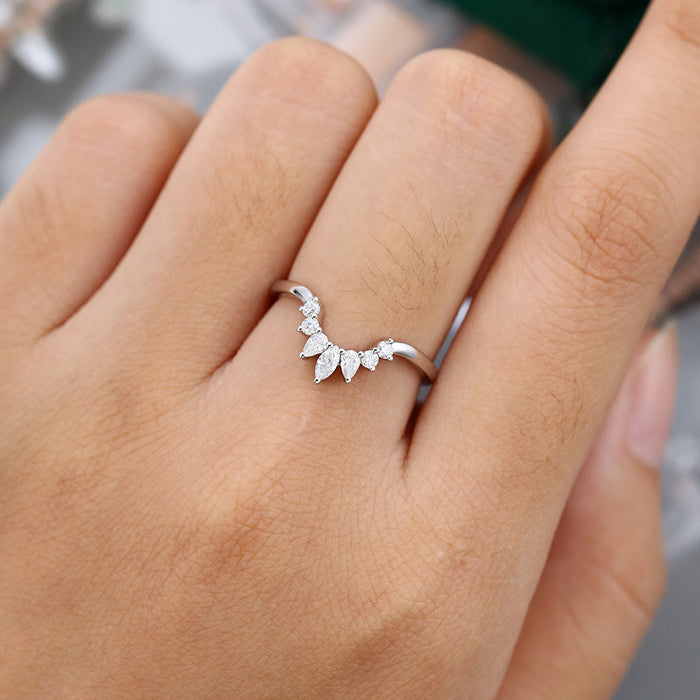 Round, Marquise and Pear moissanite sunburst curved wedding band, worn on the finger in white gold