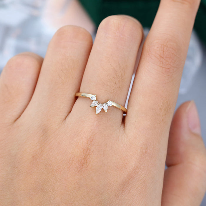Round, Pear and Marquise moissanite fan curved wedding band, worn on the finger in yellow gold