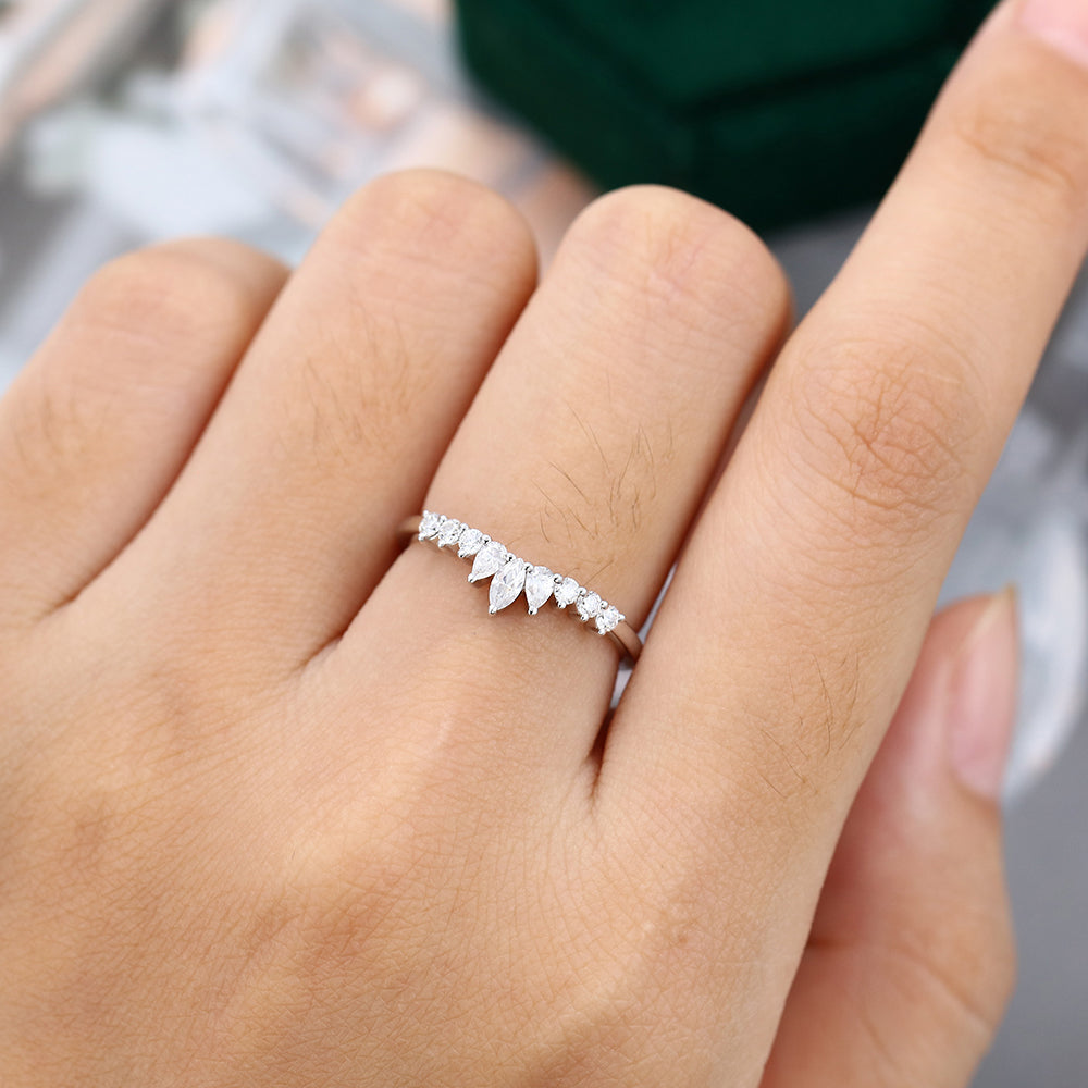 Round, Pear and Marquise moissanite graduated crown curved half eternity wedding band, worn on the finger in white gold