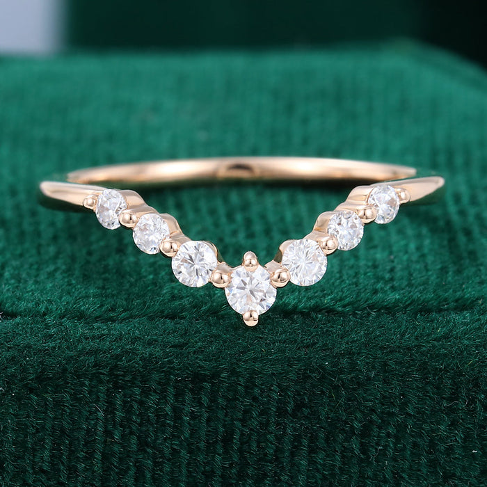 Round moissanite spaced stone v curved wedding band, front view in rose gold