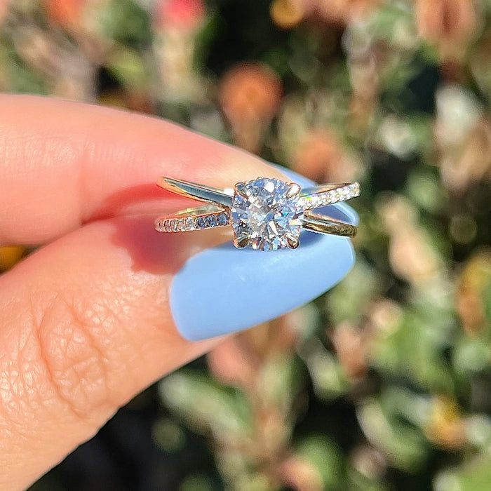 Round cut moissanite split shank engagement ring in gold