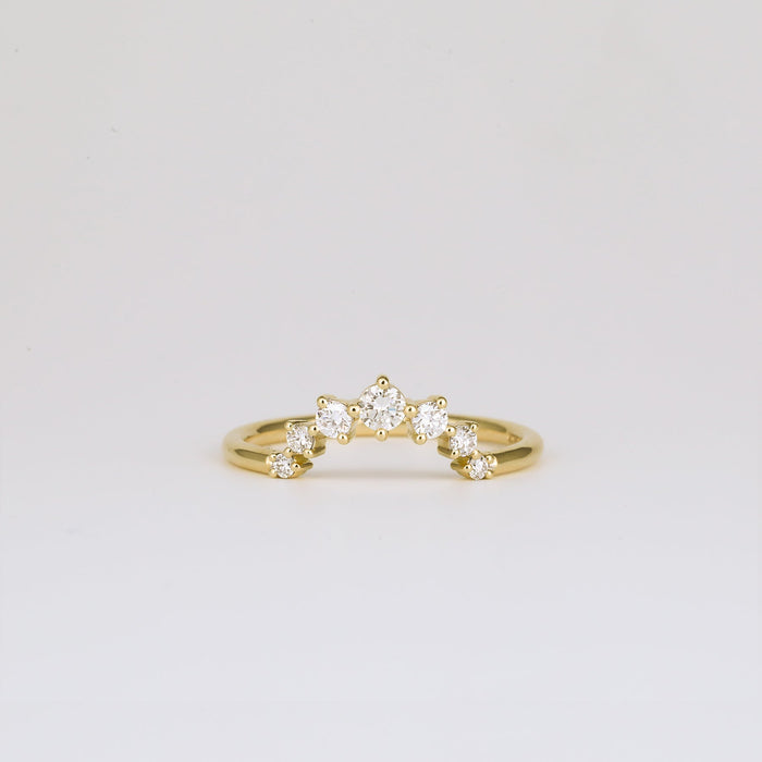 Round moissanite curved wedding band in yellow gold, front view