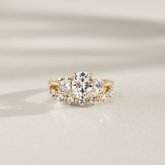 Oval cut lab grown diamond three stone ring with a curved band, sold separately